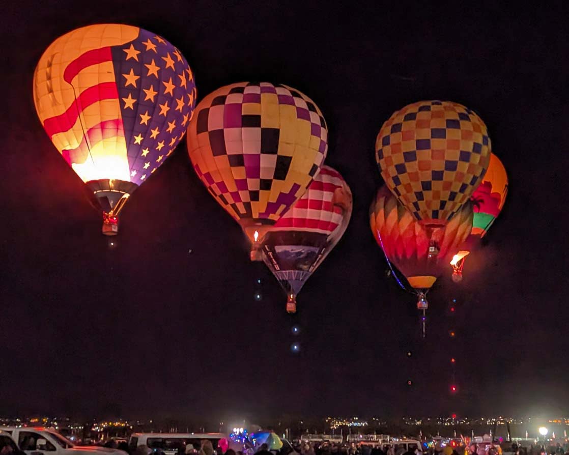 the first balloons of the morning going up at the Albuquerque International Balloon Fiesta