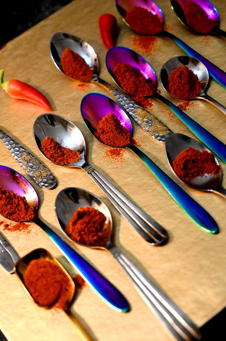 close up shot of chili powder on spoons