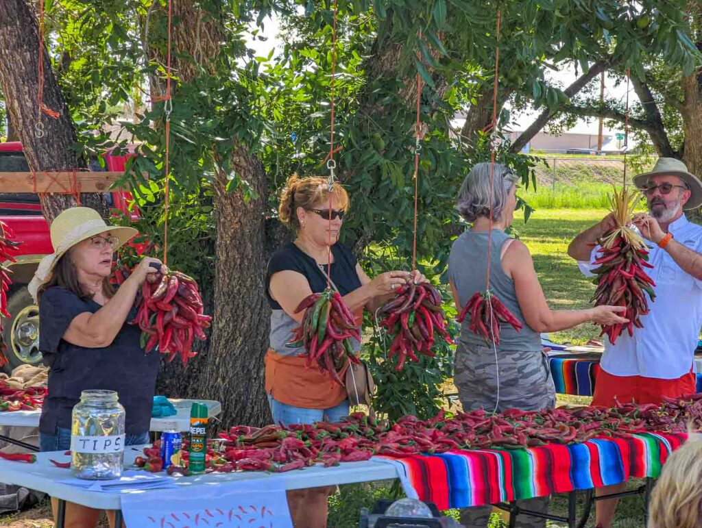 people learning to tie chile ristras at the Hatch Chile Festival